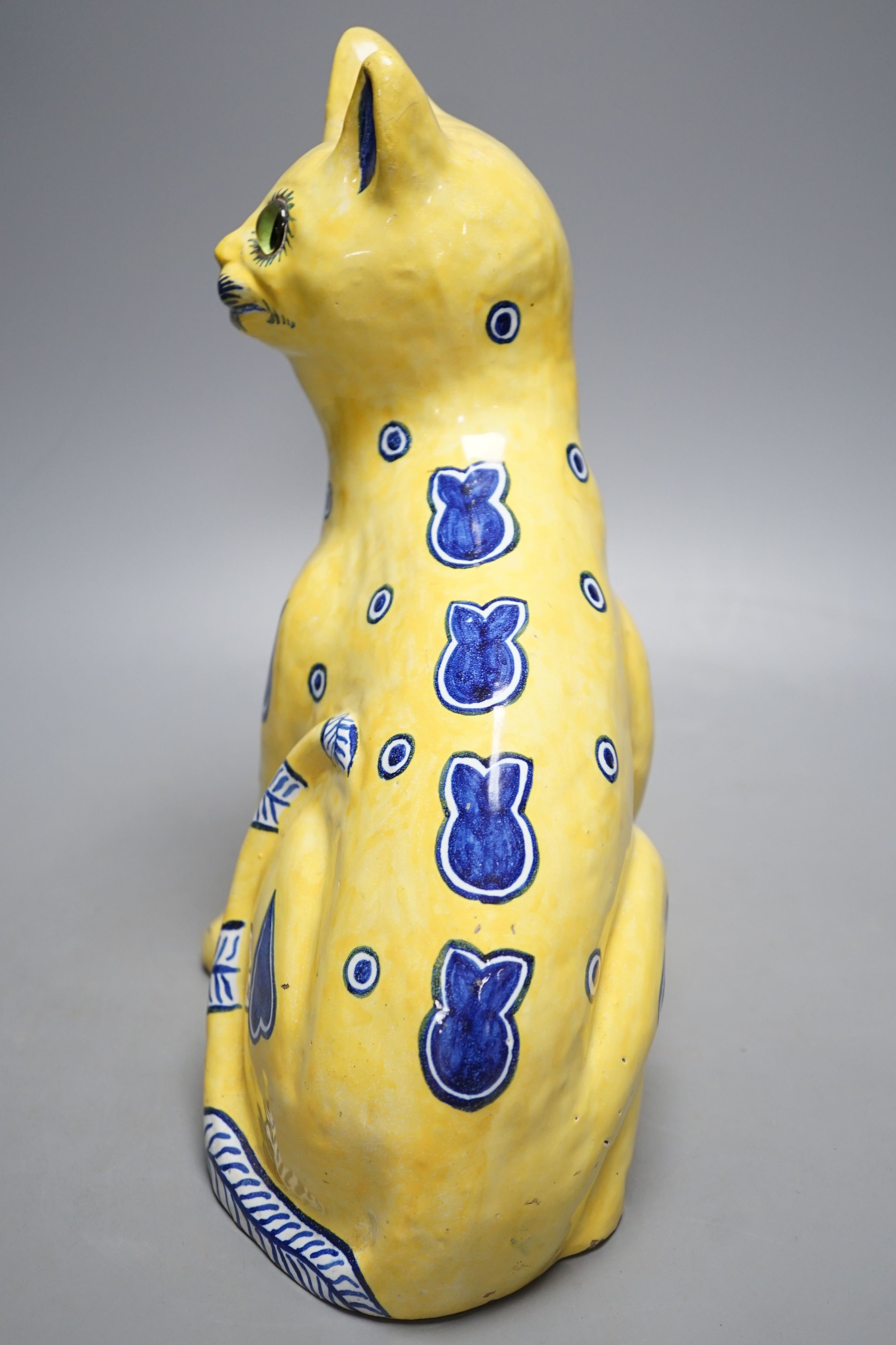 A Mosanic Galle style seated yellow and blue faience cat - 31cm tall